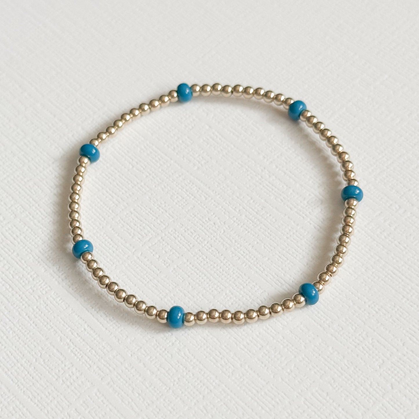 Dainty Blue Splash Bracelet in Gold