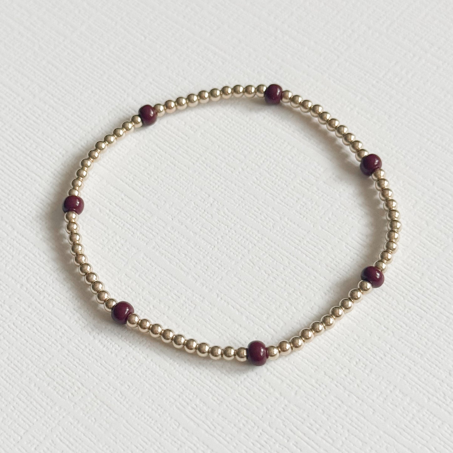 Dainty Maroon Splash Bracelet in Gold