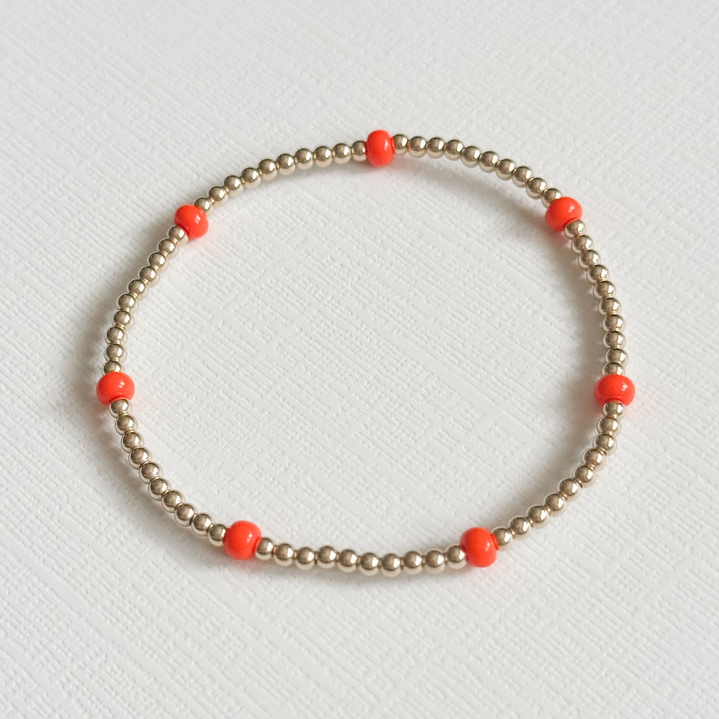 Dainty Orange Splash Bracelet in Gold